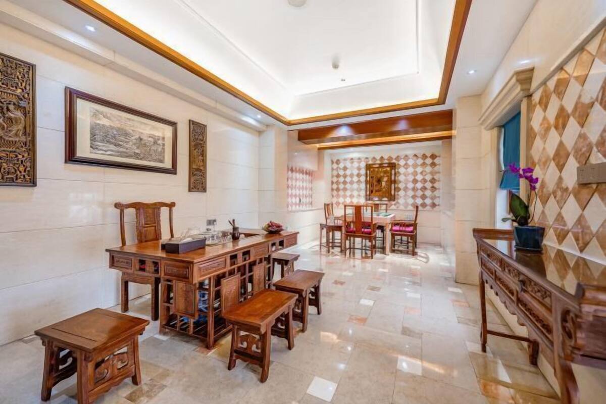 A traditional-style dining area with wooden furniture and a tiled floor.