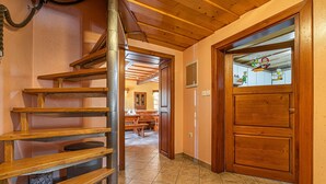 A wooden staircase leading to a second floor, a wooden door with a window, and a tiled floor. - Kunstek Farmhouse w/ Private Sauna, Rogatec, Slovenia (Rogatec)