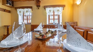 A dining table set with white plates, clear wine glasses, and a central decorative piece. - Kunstek Farmhouse w/ Private Sauna, Rogatec, Slovenia (Rogatec)