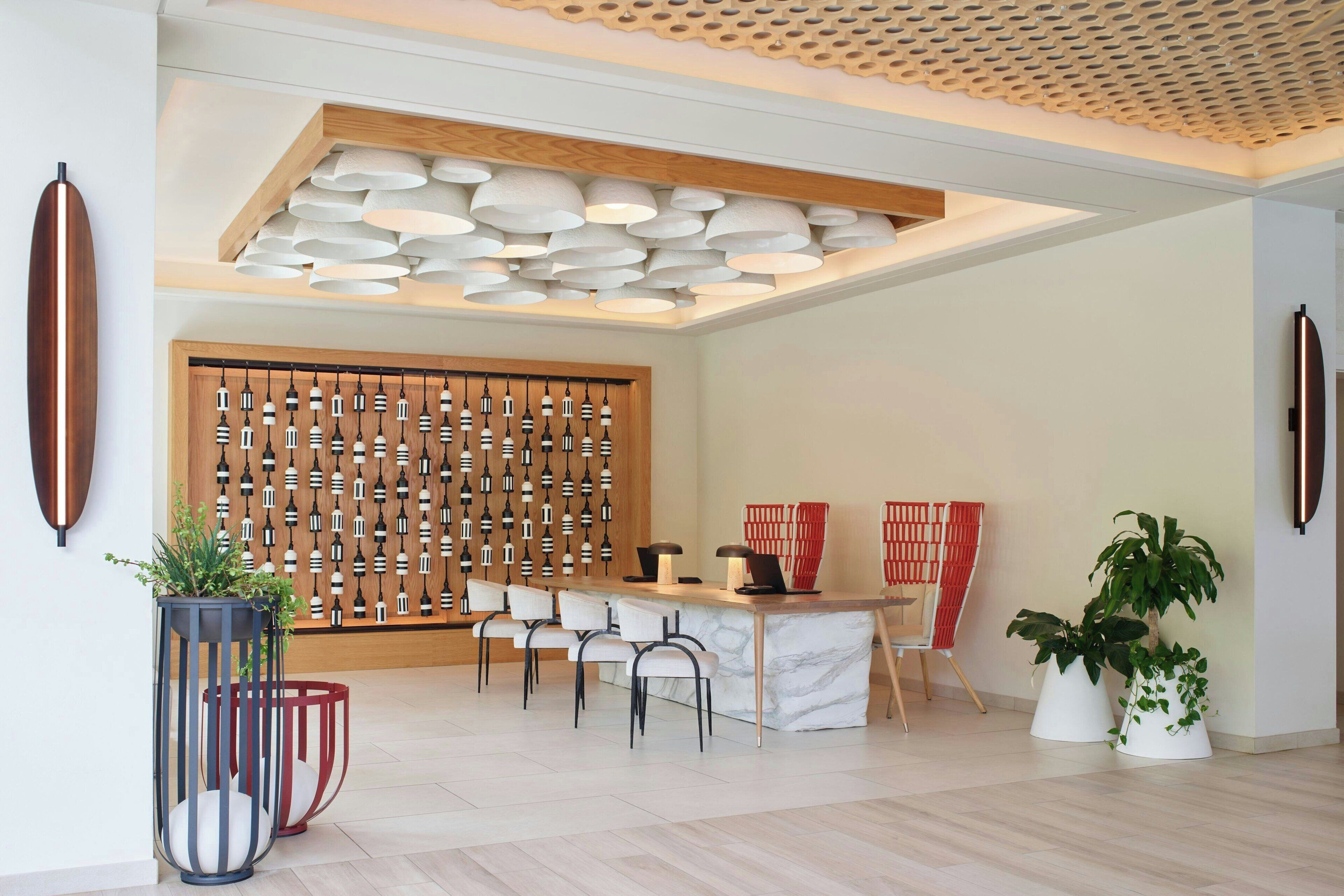 A modern dining area with a wooden partition, a marble bar, and several chairs.