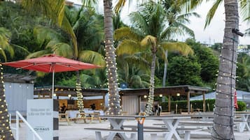 A beachside bar named "The Salt Shack" with outdoor seating and palm trees.