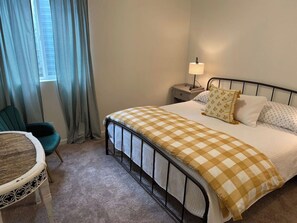 Bedroom with a yellow gingham comforter and teal accents