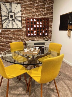 Game wall with giant Connect Four and a TV