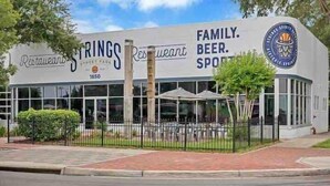 A restaurant named Springs with a sign indicating it is a family beer sports venue. - 6x Gamer Themed 2BR Apts - Close to Stadium! (Jacksonville)