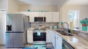 A modern kitchen with white cabinets, stainless steel appliances, a microwave, oven, and a dishwasher. - PERFECT, NEW! 6 Min to Dis, On Lake, Brand Name Beds, Big  T.Vs, Steps to Pool.  (Kissimmee)