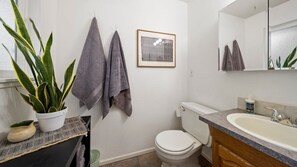 Bathtub, hair dryer, towels, shampoo