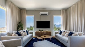 A modern hotel room with two sofas, a coffee table, and a TV. - Belle Vue - Altea, Costa Blanca (Altea)