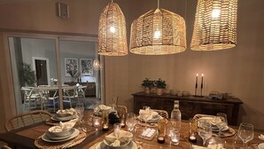A dining table set for six with wicker placemats, candles, and glassware. - Belle Vue - Altea, Costa Blanca (Altea)