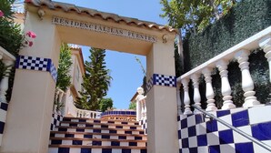 A set of stairs leading up to a sign reading "RESIDENCIAL FUESTES" with a checkered blue and white tile design. - Confort Apartamento con Excelentes Vistas al mar (VC)