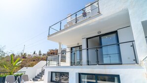 A modern two-story building with a swimming pool, outdoor seating, and a staircase leading to the upper floor. - Villa Luxuria Private Pool by Casasol (Nerja)