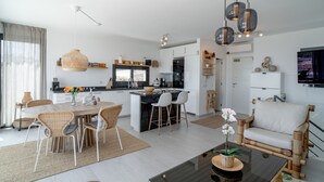 A modern kitchen with white cabinets, a central island, and hanging pendant lights. - Villa Luxuria Private Pool by Casasol (Nerja)
