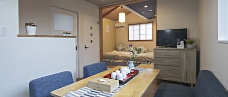 Classic Quadruple Room | Living area | 24-inch flat-screen TV with cable channels