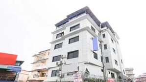 A multi-story building with a modern architectural design, featuring balconies and air conditioning units. - MeroStay 186 Hotel RR (Kathmandu)