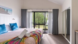 A hotel room with a bed, a view of greenery through the window, and a balcony. - At Forest Stay | Apartment in Margaret River | New Listing (Margaret River)