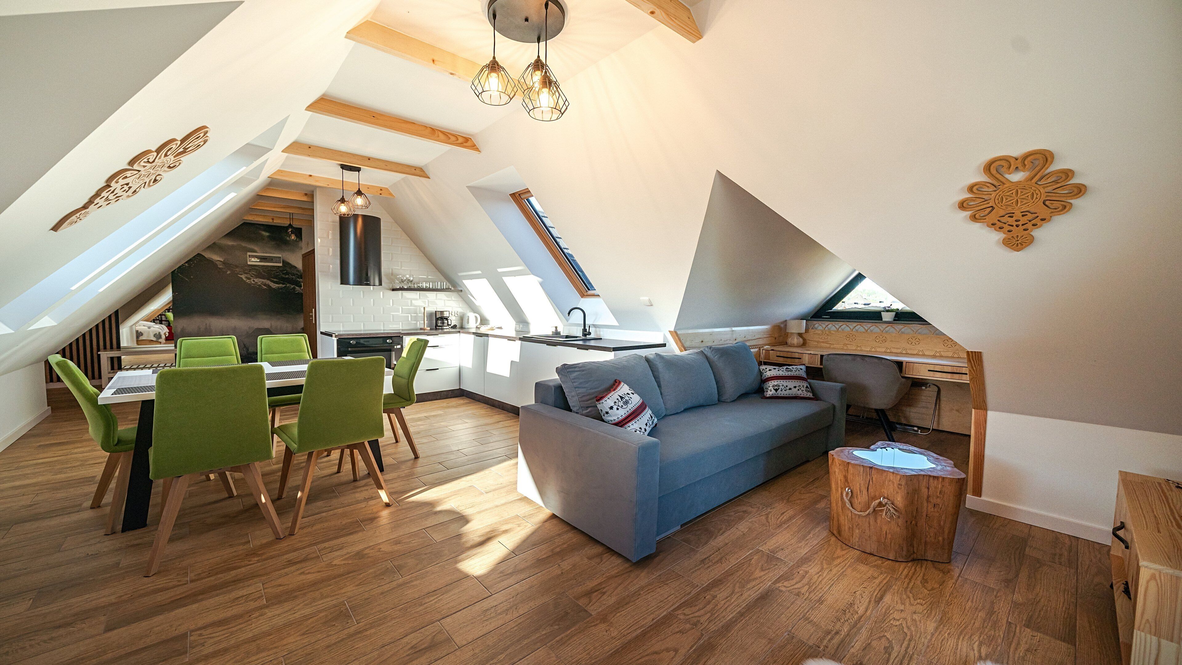 A modern loft apartment with a dining area, kitchen, and living space.