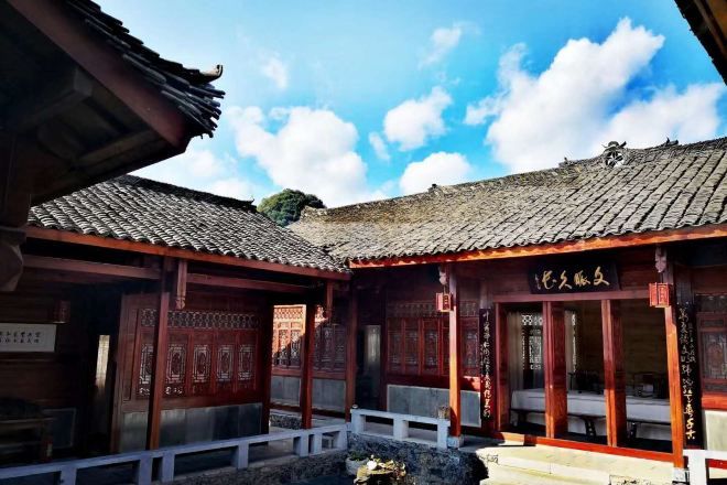 A traditional building with a tiled roof and wooden structures.
