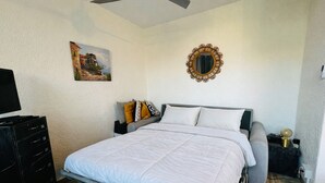 A bedroom with a bed, a dresser, a nightstand, a mirror, and a painting on the wall. - Apartment for 4 in Argelès-sur-Mer with garden and garage (Argelès-sur-Mer)