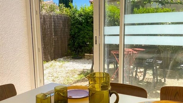 A dining table set with plates, cutlery, and a pitcher.