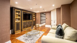 A modern living room with a sofa, a coffee table, and built-in shelving.