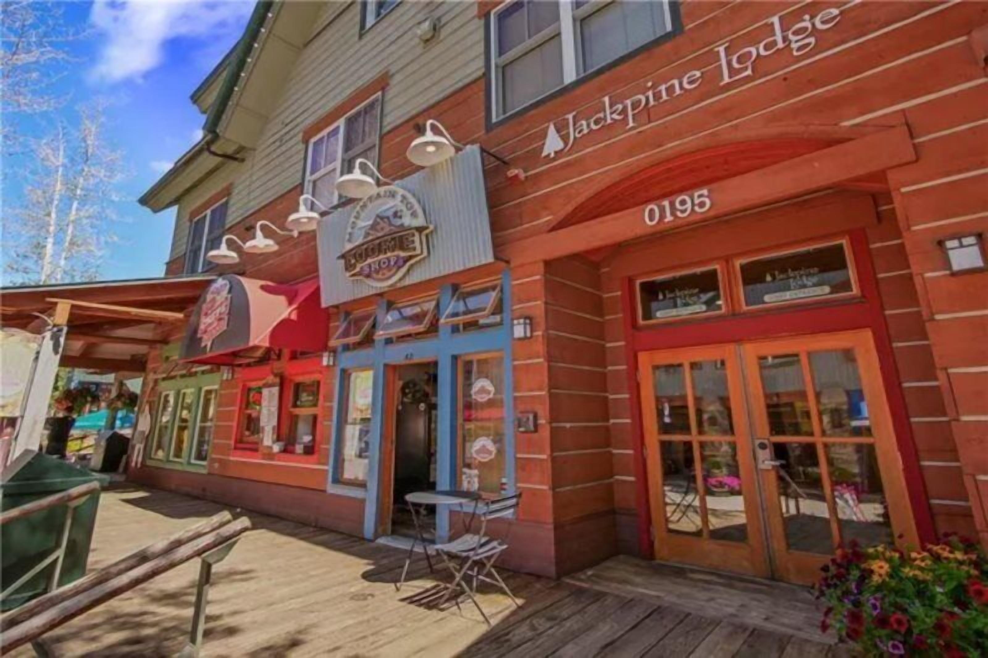 A building with a sign reading "Jackpine Lodge 0195".