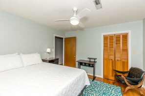 A bedroom with a bed, a desk, a chair, a ceiling fan, and a wardrobe. - The Knotty Hooker - Classic 4BR Soundfront Home - Pet Friendly! (Surf City)