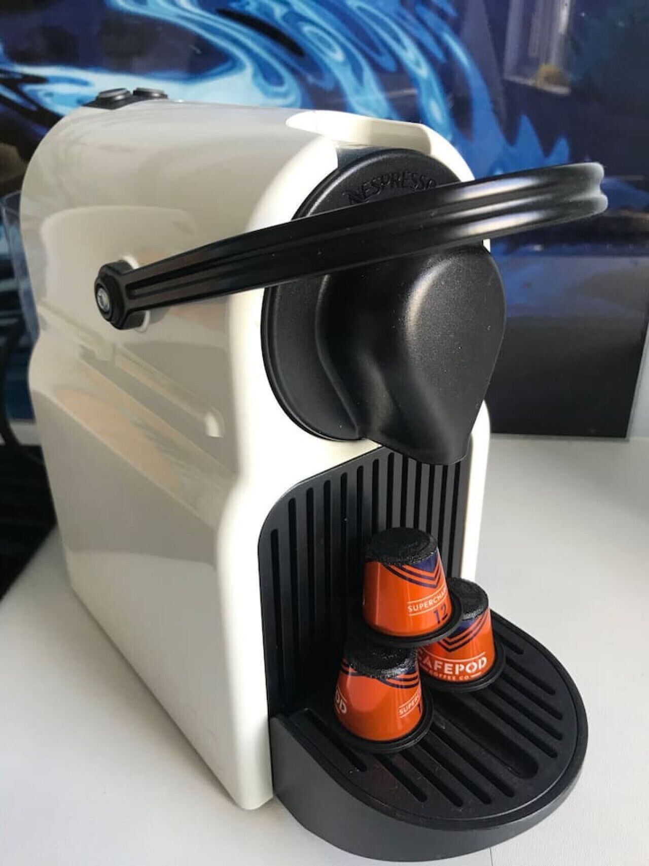 A coffee machine with two coffee pods inserted.