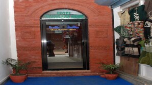 A hotel entrance with a sign reading "HOTEL TRAVELERS HOME" and a glass door. - MeroStay 192 Home HTS (Kathmandu)