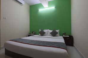 Relax in a stylish room with a large bed, bedside tables, and a ceiling light fixture.