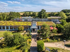 A building with a green roof, a sign for 'Dresden 01', and a 'Bistrohaus' sign.