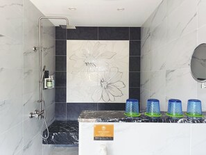 Deluxe Quadruple Room | Bathroom | Hair dryer, slippers