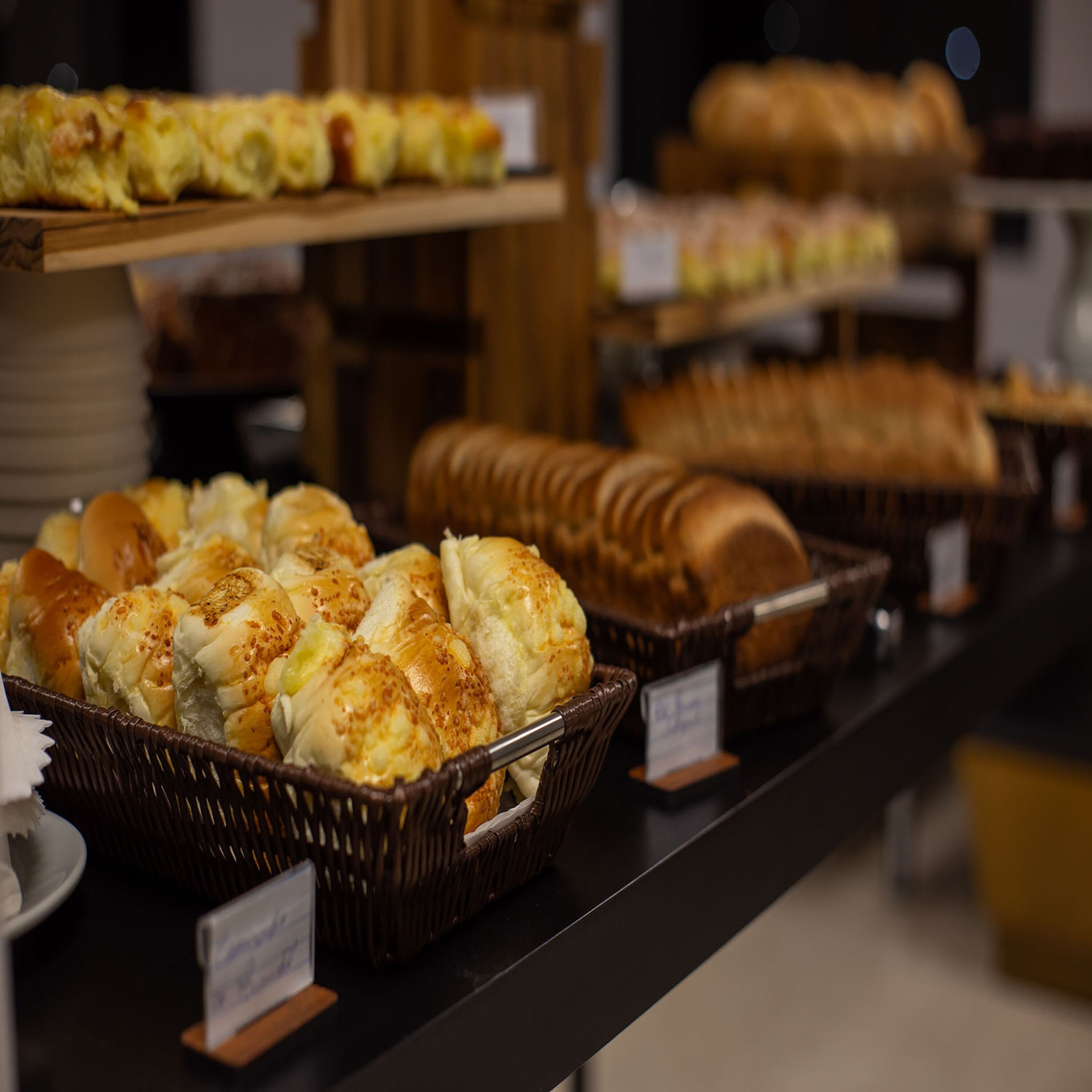 A buffet with various baked goods including bread and pastries.