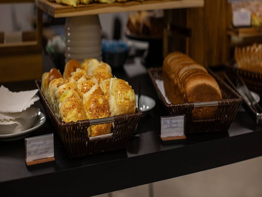A buffet with various baked goods including bread and pastries.