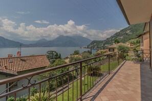A balcony with a view of a lake and mountains.