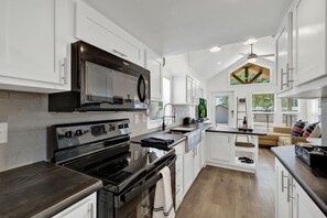 Enjoy cooking in this well-lit kitchen with a central island and sink.