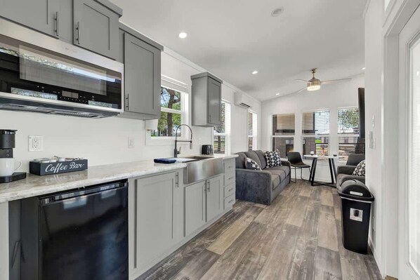 Fridge, microwave, coffee/tea maker, cookware/dishes/utensils