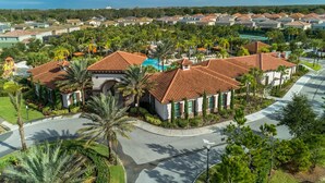 A residential area with houses, a swimming pool, and a curved road. - 4329ac - Solterra Gated Resort 5 Bedroom Home by RedAwning (Davenport)