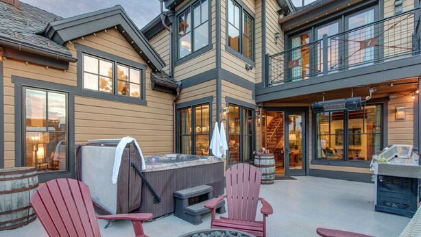 A modern house with a hot tub, outdoor seating, and a stone fire pit. - 1138 Skiers Heaven! Luxury Home Close To Park City Mountain! Two Hot Tubs & Gorgeous Outdoor Space! 6 Bedroom Home by RedAwning (Park City)