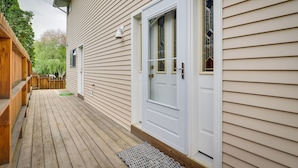A wooden deck with a white door and a window with a decorative glass design. - Charming Elko Home w/ Pool Table! (Elko)