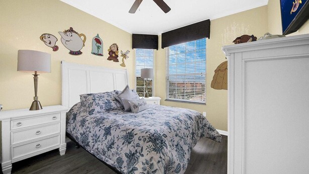 A bedroom with a bed, nightstands, a lamp, and wall decorations. - Last Minute Disney Getaway! Themed Bedrooms & Private Balcony. Book Now! #65331 (Orlando)