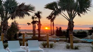 A beach setting with palm trees, lounge chairs, and a hammock. - Last Minute Disney Getaway! Luxury Villa with Private Pool & Game Room. Book Now! #87165 (Orlando)