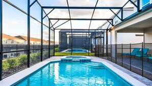 A swimming pool with a glass enclosure, a hot tub, and lounge chairs. - Last Minute Disney! Private Pool, Hot Tub, Game Room & Themed Bedrooms. Book Now! #87201 (Orlando)