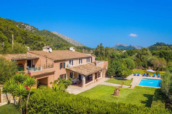 Overlooking a lush garden and pool, this villa offers a serene and setting with a spacious balcony.