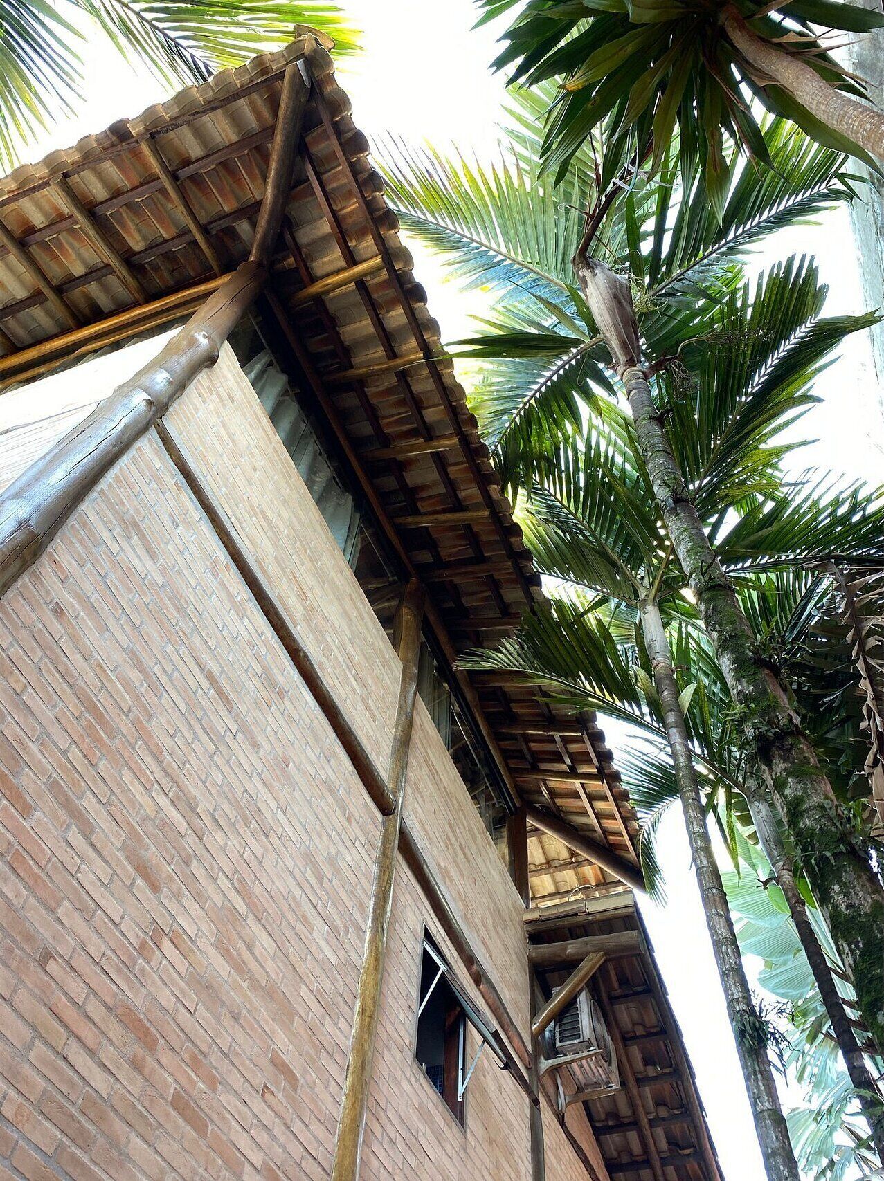 A building with a brick facade and a wooden roof structure.