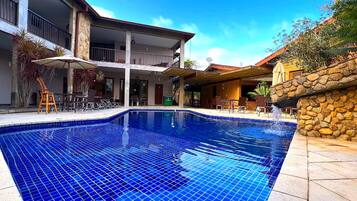 Relax by the pool surrounded by comfortable seating and scenic views.