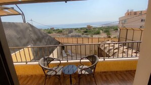 A balcony with a view of the sea and buildings. - Lacasa chalet panoramic view to dead sea (Sweimeh)