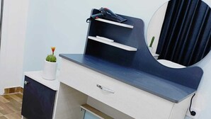 A modern desk with a chair, a small plant, and a mirror. - Lacasa chalet panoramic view to dead sea (Sweimeh)