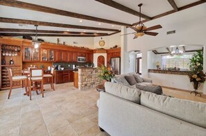 Relax in this inviting living area with a comfortable sofa, dining space, and stone fireplace.