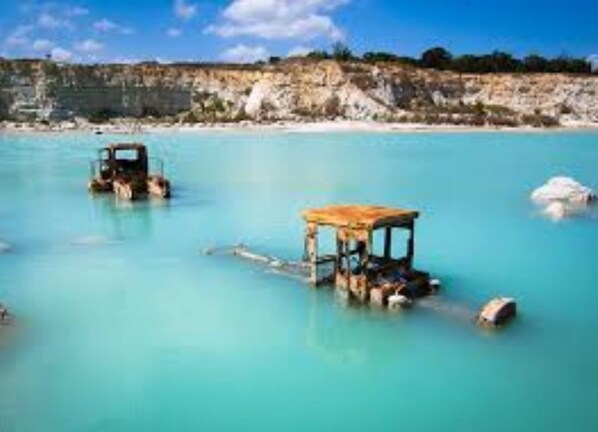 Guests can enjoy serene views of the turquoise waters and surrounding rocky coastline.