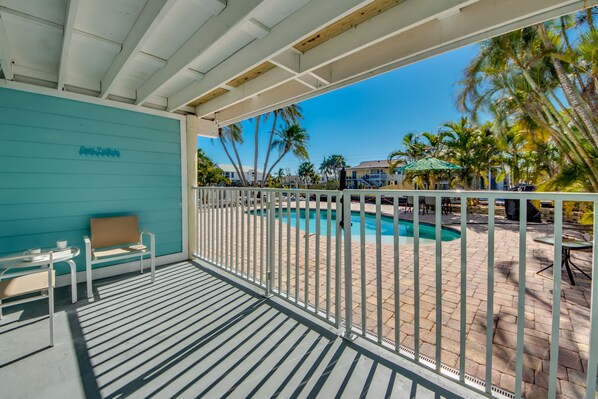 Relax by the pool surrounded by palm trees and scenic views.