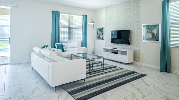 Relax in this stylish living room with a sofa, flat-screen TV, and entertainment unit.